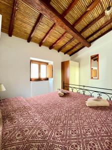 ポザーダにあるCasa Ginepro-Romantica casa vista mareのベッドルーム1室(赤いベッドカバー付きの大型ベッド1台付)