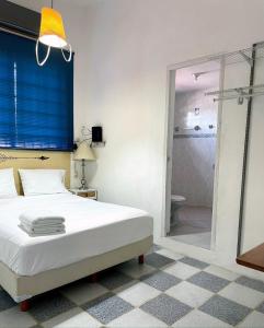 a bedroom with a white bed and a shower at Casa Siloe in Campeche +13 photos