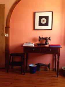 a table in a room with an orange wall at Sintra Small Hostel in Sintra