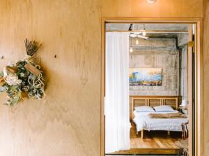 a bedroom with a bed and a mirror at Guesthouse RICO in Wakayama