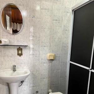 a bathroom with a sink and a mirror at Chalés Eucaliptos in Monte Verde