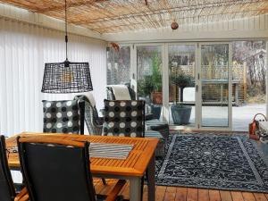 メルビストランドにあるHoliday home MELLBYSTRAND Xのリビングルーム(木製テーブル、椅子付)