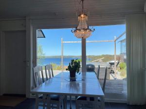 a dining room with a table and a chandelier at Holiday home Trollhättan II in Trollhättan