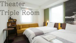 a hotel room with two beds and a couch at Henn na Hotel Tokyo Haneda in Tokyo