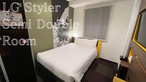 a small bedroom with a white bed in a room at Henn na Hotel Tokyo Haneda in Tokyo