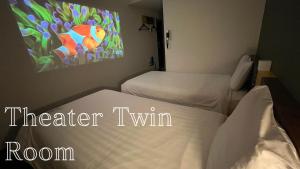 a room with two beds and a painting on the wall at Henn na Hotel Tokyo Haneda in Tokyo