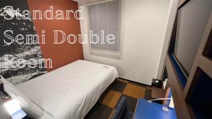 a small bedroom with a bed and a window at Henn na Hotel Tokyo Haneda in Tokyo