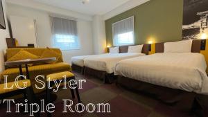 a hotel room with two beds and a table at Henn na Hotel Tokyo Haneda in Tokyo