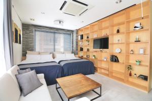 - une chambre avec deux lits et un canapé dans l'établissement TAKETO STAY TERRACE ONE, à Sapporo