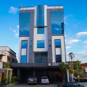 a building with cars parked in front of it at Vari Park - Comfort Stay in Dindigul