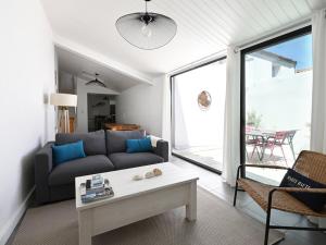 a living room with a couch and a table at Maison Les Portes-en-Ré, 3 pièces, 4 personnes - FR-1-434-98 in Les Portes