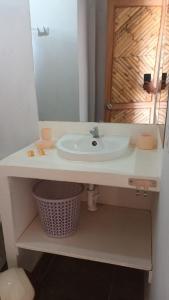 a bathroom with a sink and a mirror at Bungalows Sol y Mar in Canoas De Punta Sal