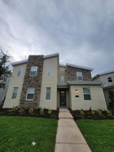 a large house with a sidewalk in front of it at Winterfield Storey Lakeview 4173 in Kissimmee