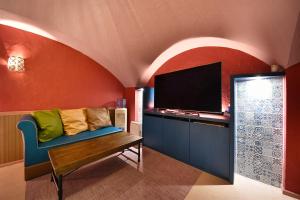 a living room with a couch and a flat screen tv at Hotel LALA minato - Adult Only in Nagoya