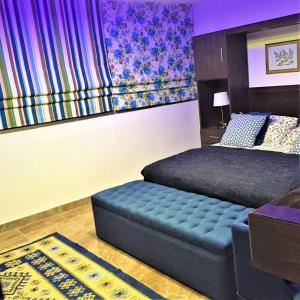 a bedroom with a bed and a futon and a couch at The Royal Luxury Superior Queen cot in Amman