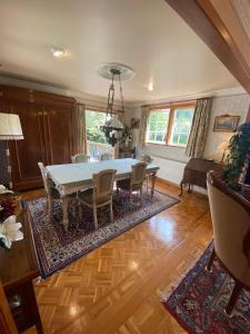 a dining room with a table and chairs at Twin Totara Cottage in Upper Hutt +9 photos