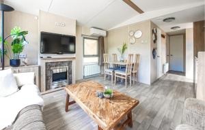 a living room with a couch and a table at 2 Bedroom Nice Home In Heinkenszand in Heinkensand