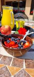 a bowl of fruit and vegetables on a table at Penzión Vila Petra Bed&Breakfast in Veľký Slavkov