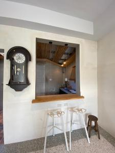 a kitchen with two stools and a mirror at 四季小空間 in Pingtung City