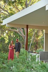 a man and a woman standing in front of a house at Eight Willows Retreat in Margaret River Town