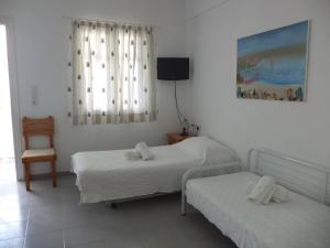 Ένα ή περισσότερα κρεβάτια σε δωμάτιο στο Ξενοδοχείο Ακταίον