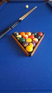 a pool table with a tray of balls and cues at Apartamenty Holiday Slaw jacuzzi bilard in Ustarbowo