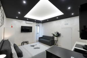 a living room with a bed and a couch at Suite16 & spa in Barletta
