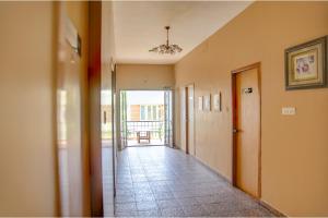 an empty hallway with a hallway leading to a room at FabHotel Hibiscus Stays in Chennai
