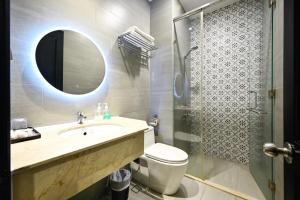 a bathroom with a toilet and a sink and a shower at Ohana Hotel - Near Bitexco in Ho Chi Minh City