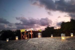 a table with lights on top of a field at Wild Trails Yala by Suri in Yala
