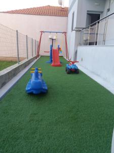 a playground with three toy cars on the grass at Star Studios in Stavros +56 photos