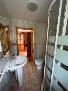 a bathroom with a sink and a toilet at Casa Mildi Poo Llanes in Po
