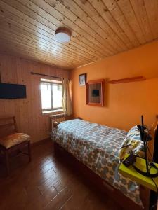 a bedroom with a bed in a wooden room at Casa Mildi Poo Llanes in Po