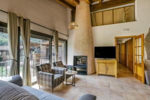 a living room with a couch and a tv at Casa rural Mas Plantalech in Vall de Bianya