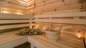 a sauna with a bucket and flowers in it at Best Boutique Hotel in Stara Zagora