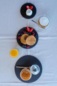 a table with plates of food and a glass of milk at La Minditta in San Teodoro