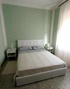Affittacamere La Foresta di Sopra في بارغا: غرفة نوم بسرير كبير وطاولتين