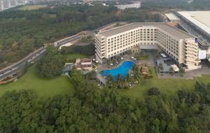 an overhead view of a large white building with a pool at Novotel Hyderabad Convention Centre in Hyderabad