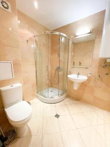 a bathroom with a shower and a toilet and a sink at SUNNY Star Dreams CONDO w PRIME LOCATION, POOL, SEA VIEW in Sveti Vlas