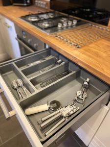 a drawer in a kitchen with tools in it at Bentley Place in Crewe