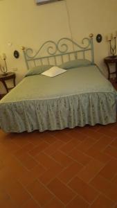 a bedroom with a bed with a metal headboard at Villa Medicea Lo Sprocco in Scarperia