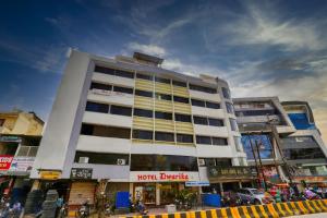 a tall white building on a city street at Hotel Dwarika Inn in Indore