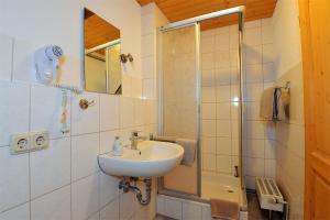 a bathroom with a sink and a shower at Ferienwohnungen Stützel in Oberellen