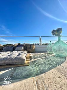 a table with two glass vases on top of a boat at Paradise Sea Terrace in Monopoli