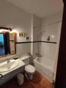 a bathroom with a sink and a toilet and a tub at Casa del Medico in Olmeda de las Fuentes
