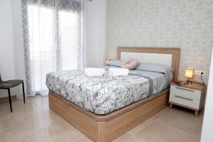 a bedroom with a bed with two pillows on it at Ático Azucarera Torre del Mar in Torre del Mar