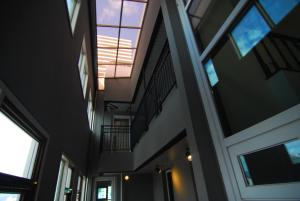 an empty hallway in a building with windows at Dynamic Guesthouse in Busan