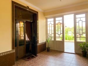 an entrance to a room with doors and plants at Safar Guest House in Samarkand