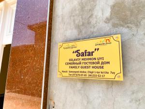a yellow sign on the side of a building at Safar Guest House in Samarkand