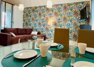 a living room with two tables and a couch at Apartamenty Villa Fiori in Sobieszewska Pastwa